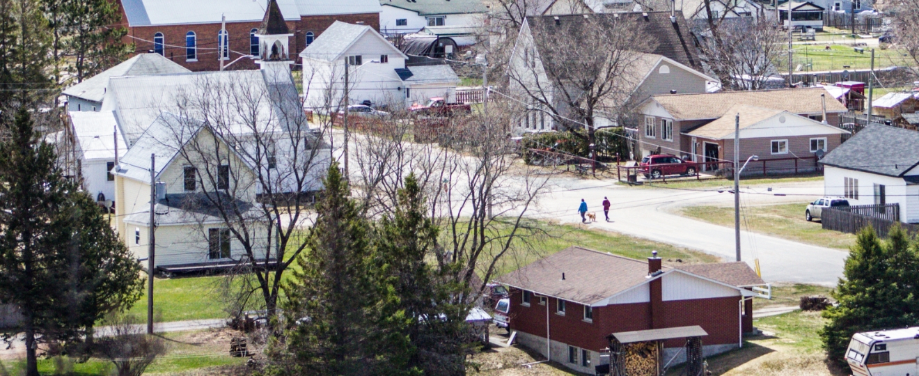Remote northern Ontario community with dispersed housing and natural surroundings illustrating decentralized water and wastewater systems designed for limited access conditions.