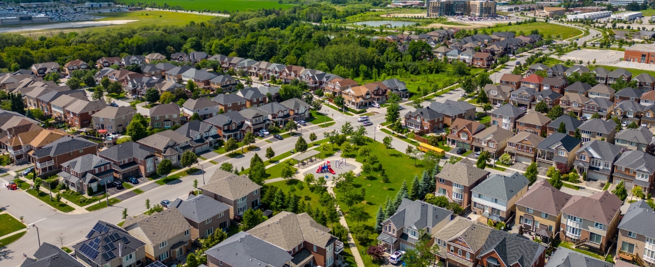 Residential community development with planned housing and infrastructure illustrating decentralized water and wastewater systems supporting expansion beyond municipal service areas.