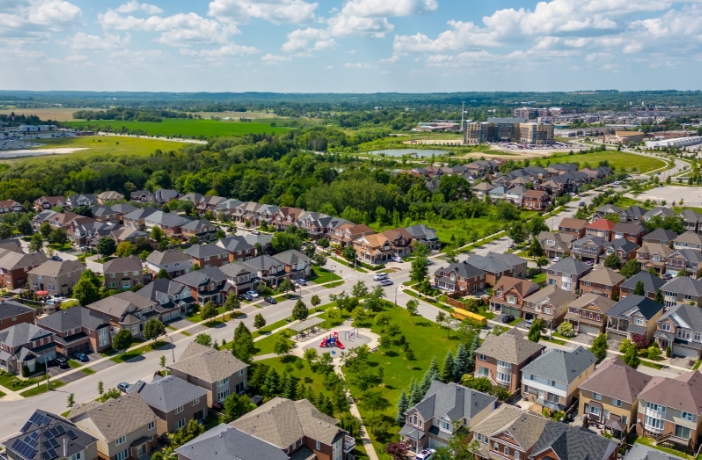 Residential community development with planned housing and infrastructure illustrating decentralized water and wastewater systems supporting expansion beyond municipal service areas.