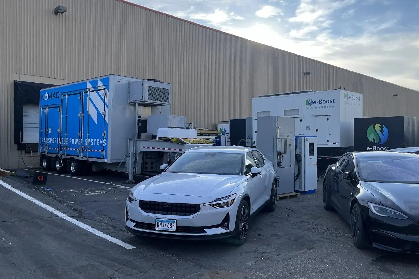 Mobile battery energy storage unit supplying power to electric vehicle chargers.