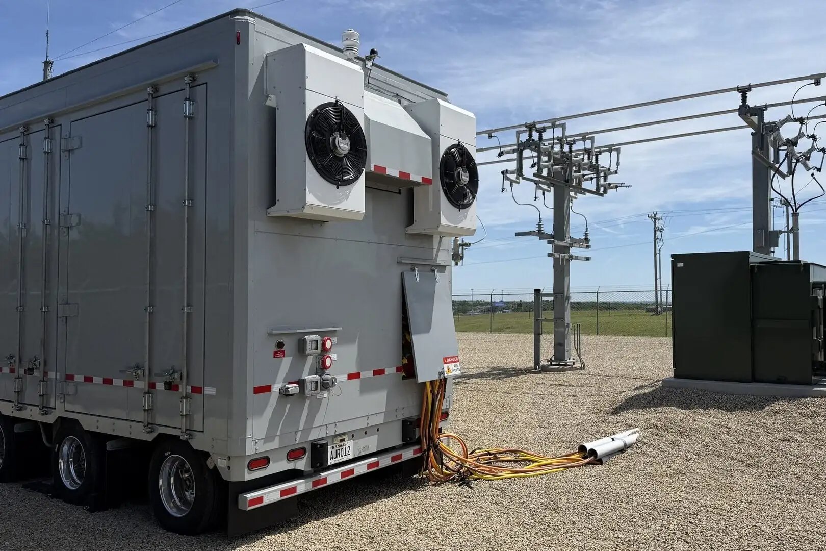 Mobile battery energy storage unit connected at an electric cooperative site for peak shaving.